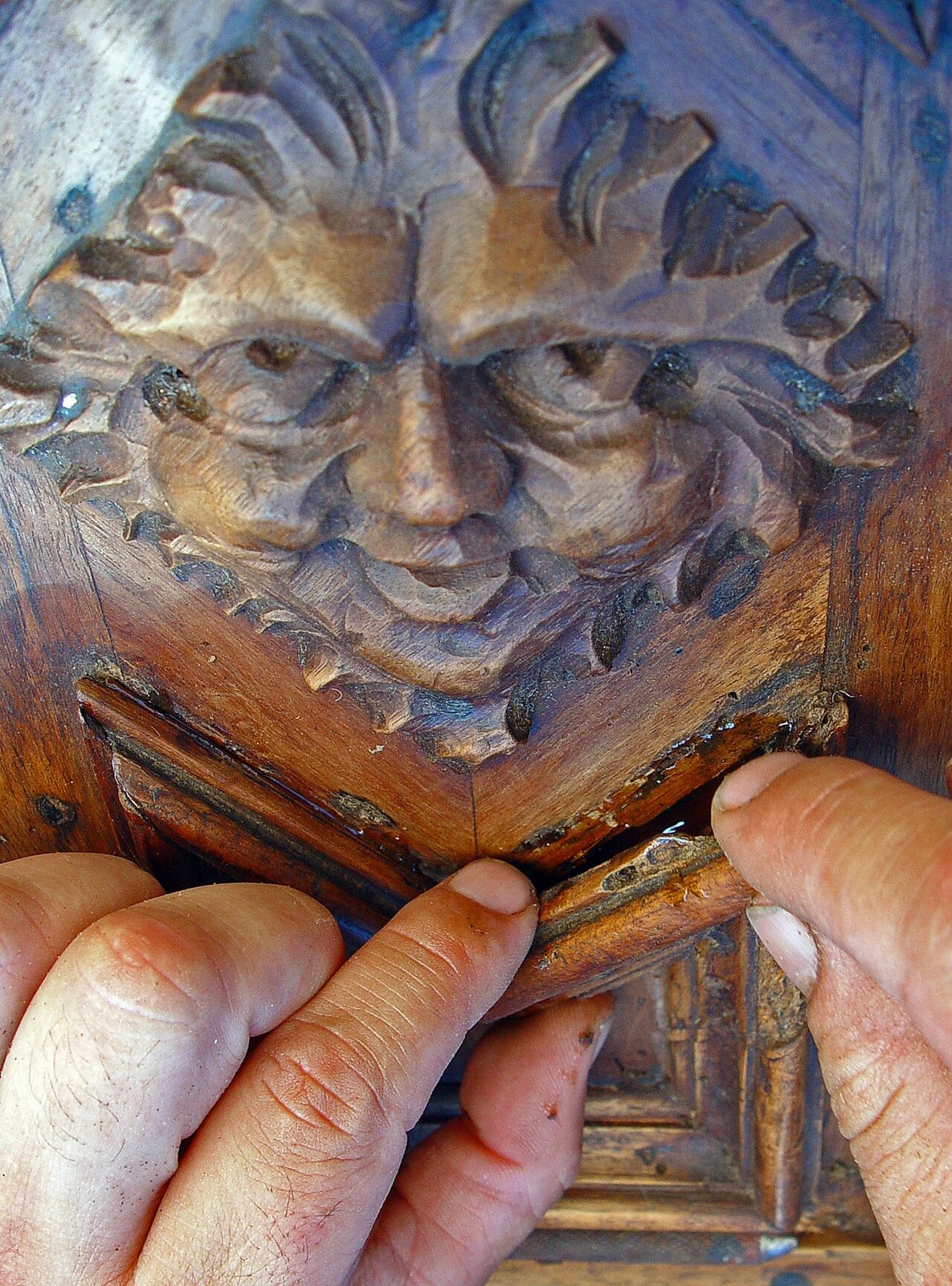 A conservator repairing a piece of furniture