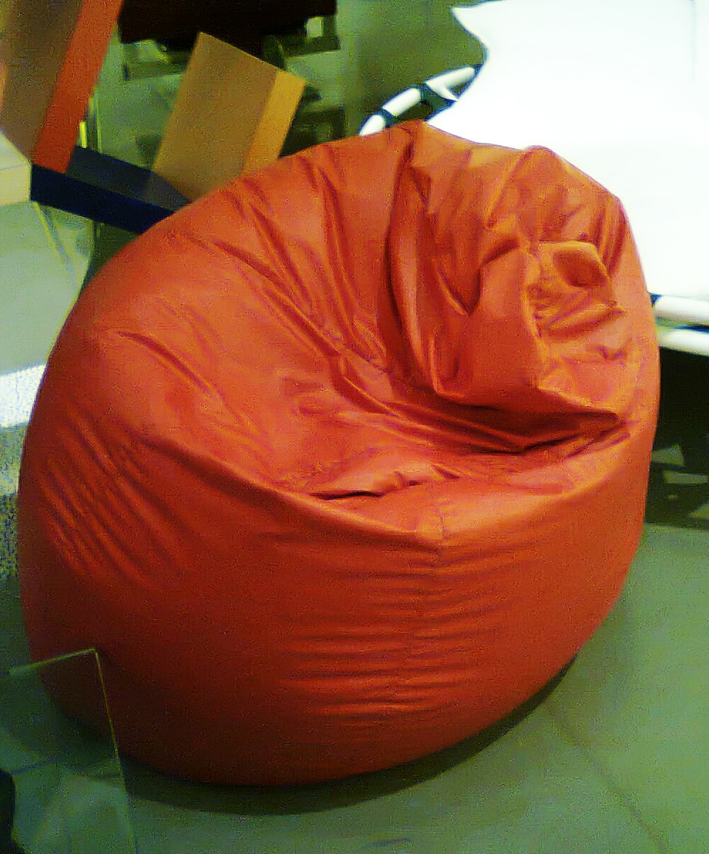Orange Sacco chair on display, showing how its filling changes the seat’s shape