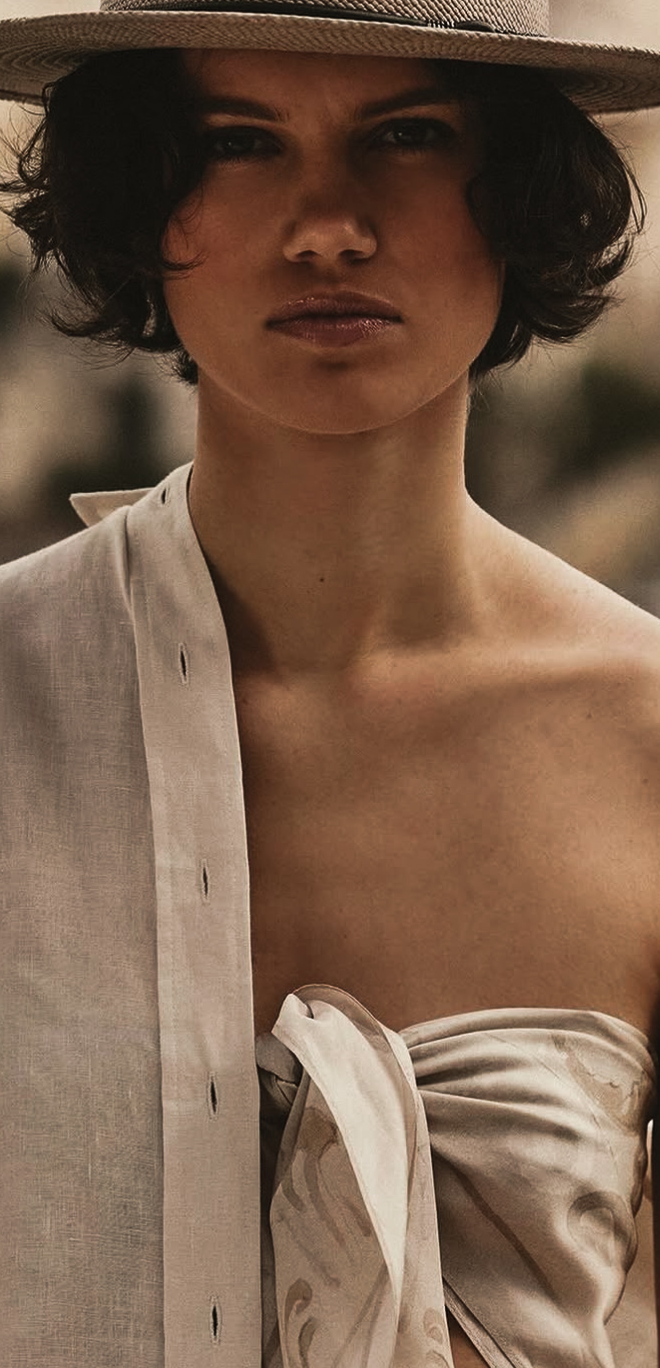 Straw hat, pale shirt and a knotted bandeau.